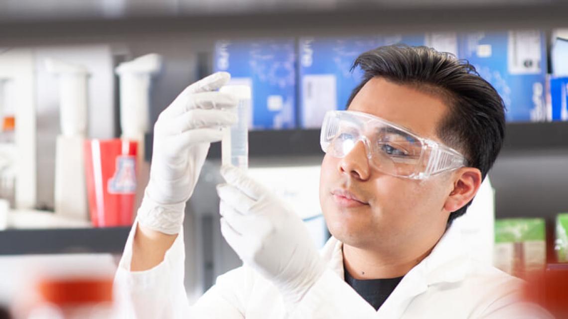 Student examining a test-tube.